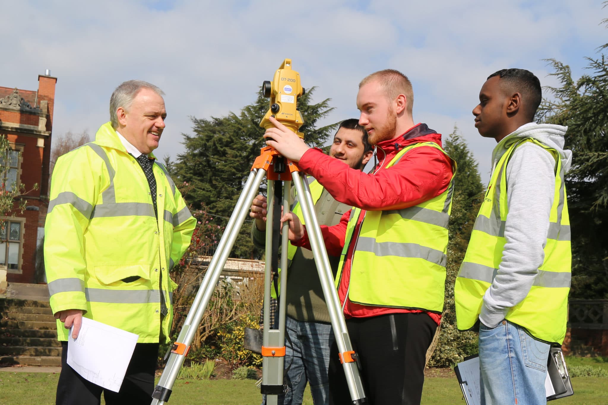 Students using equipment with tutor watching