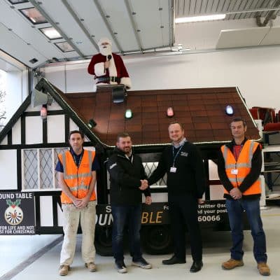 Staff at the College and the Round Table with the Santa House