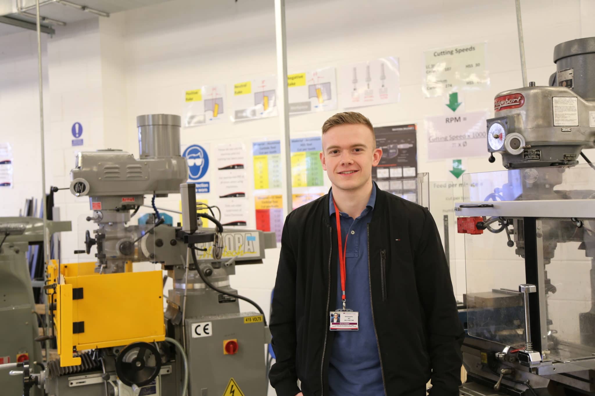Chris stands in an engineering classroom