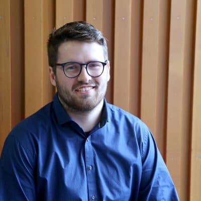 Student Oliver sits in reception of college.