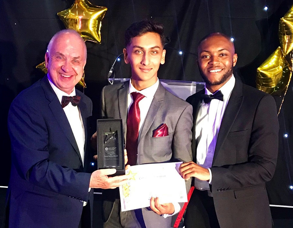 student holding awards