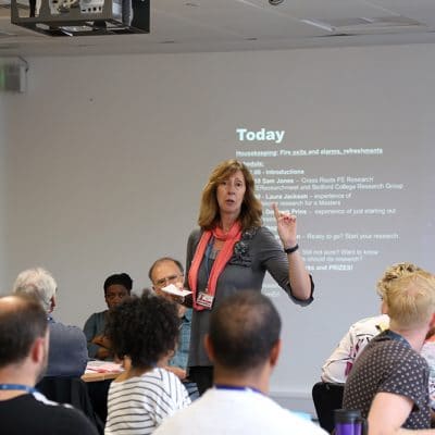 conference event speaker pointing upwards