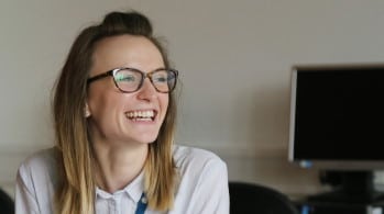 Smiling student at desk.
