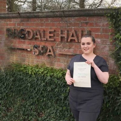 student holding certificate