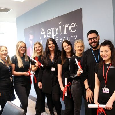 Hair & beauty students with scrolls