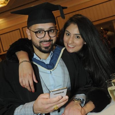 Couple at graduation holding hands