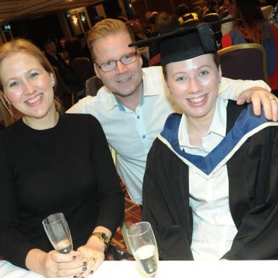 Family sat at a table at graduation