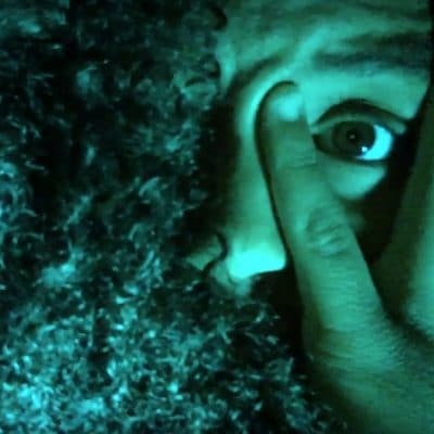 Hand over eye zoomed in to female face