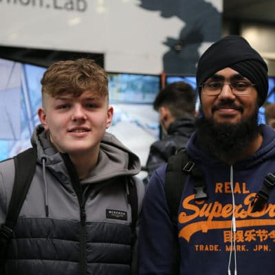 two students smiling at the event