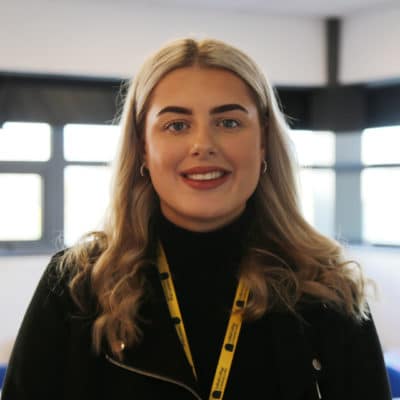 Sophie stands in classroom