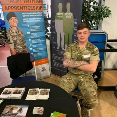 Male Army representative sat at table.