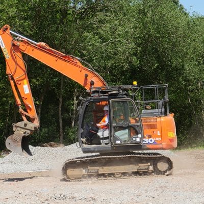 Construction workman in machinery digger