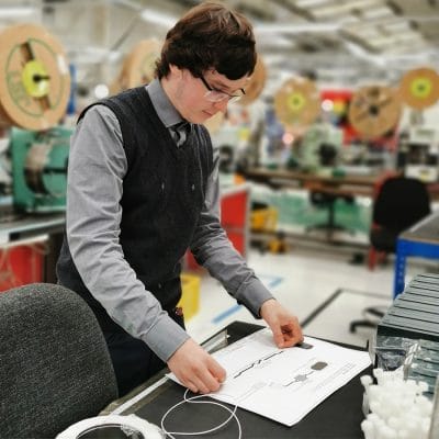 Marcus in the workshop measuring