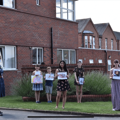 All the prize winners stood together holding certificates