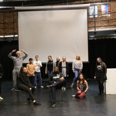 Performing Arts students stand in the theatre before show.