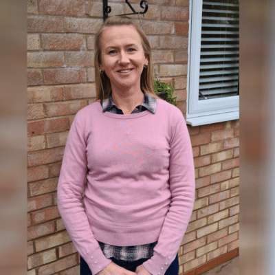 Priscilla stood outside her school.