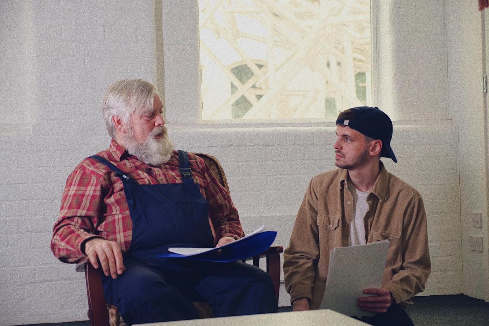 Elliot Roberts sits with the older man cast as Burt in the movie