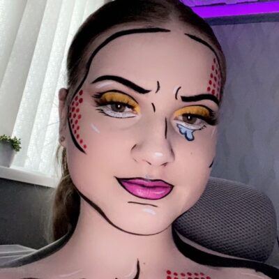 Laura creates pop art look with face definition yellow eyes and purple lips