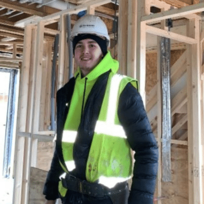 Niall stood in a hardhat on a building site