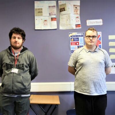 Students Rafe and James stand in their classroom