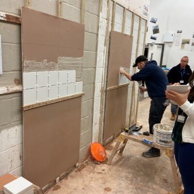 a student in a workshop tiling