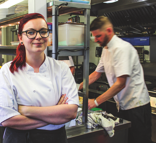 Catering student working in kitchen