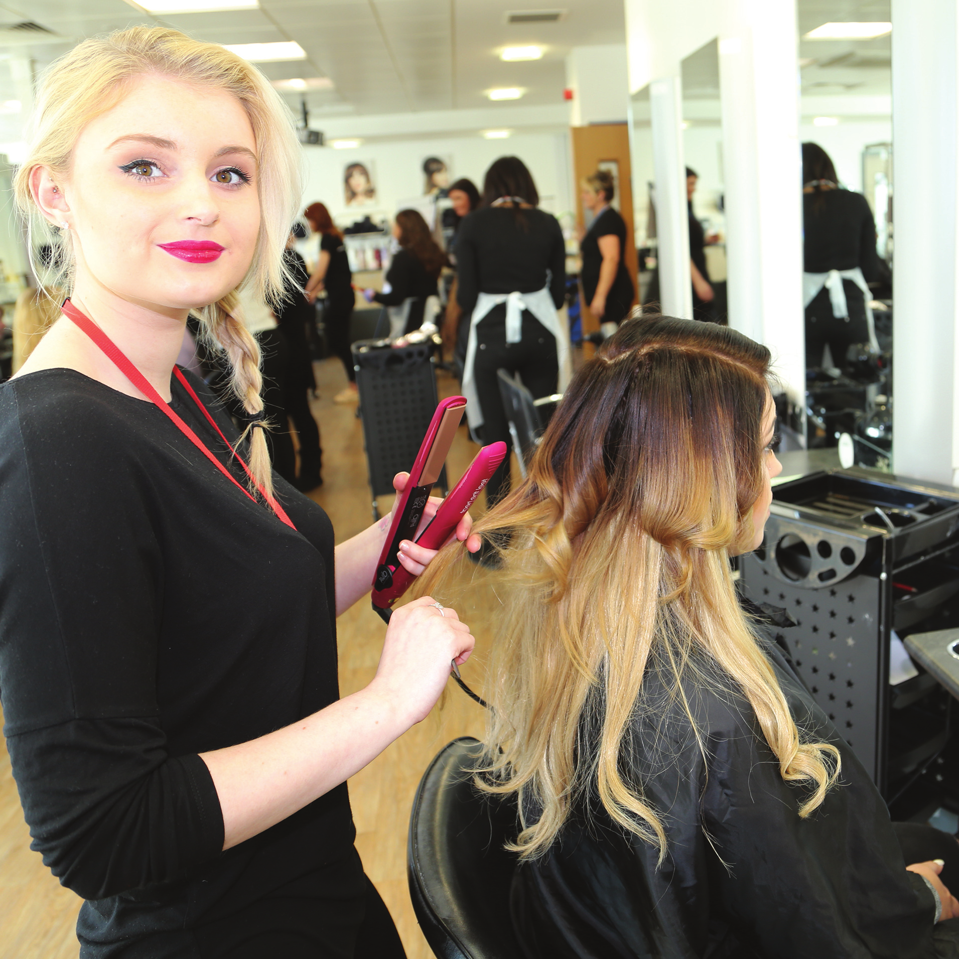 Hairdressing student curling hair