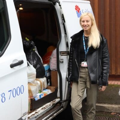 Maddie Booth standing next to the donations.