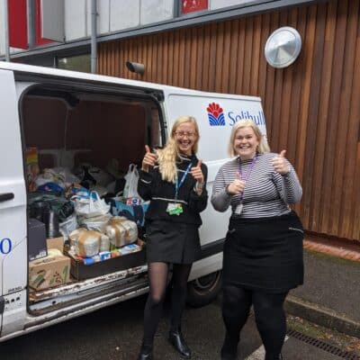 Maddie Booth (left) and Grace Wynee Willson donating essential items and clothes for Afghan refugees.