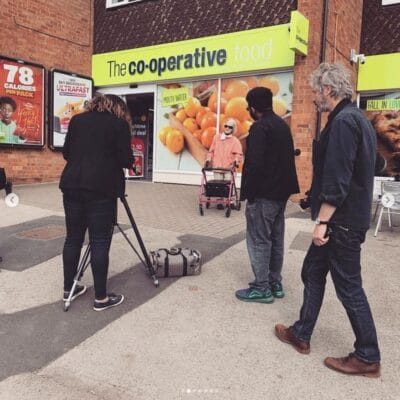 Students taking photos of an elderly lady for solihull photography course