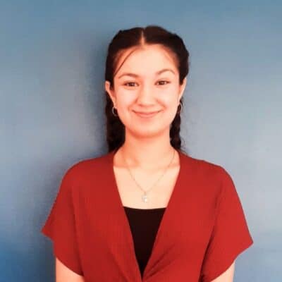 Student in red dress standing
