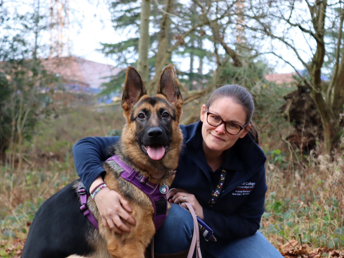 woman with arm around dog