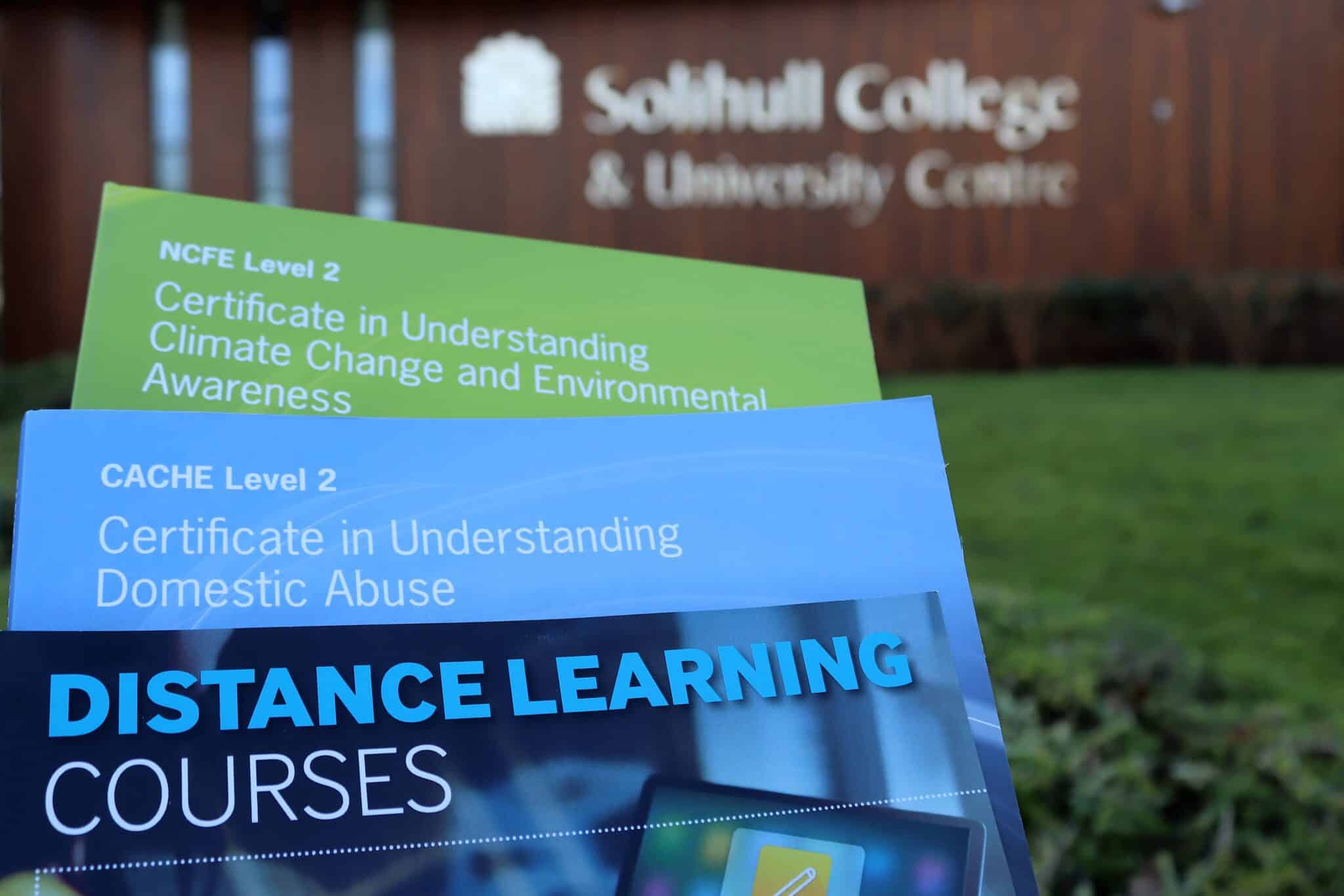 Course books in front of college building