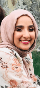 Woman wearing headscarf looking at camera smiling