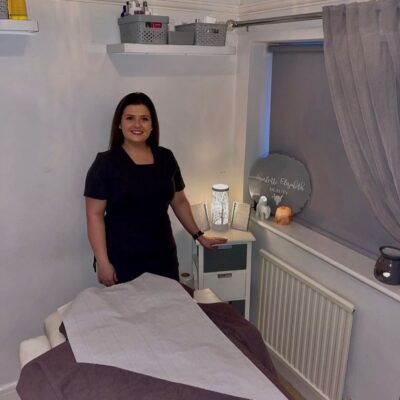 Charlotte standing with hand on side table
