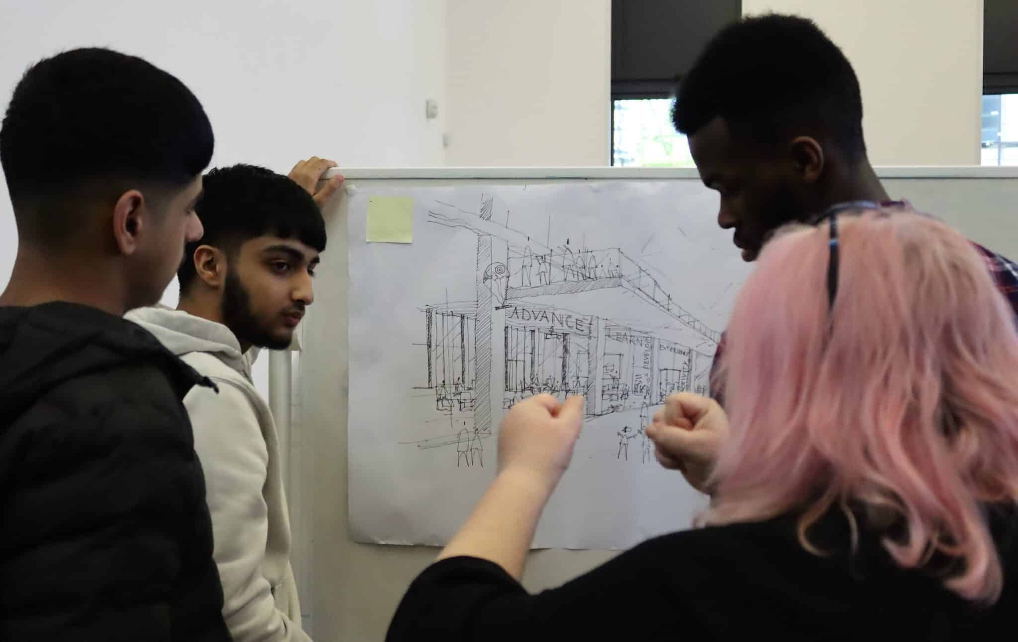 3 students looking at drawing of bulding with staff member