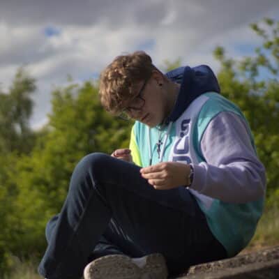 student sitting looking at knee