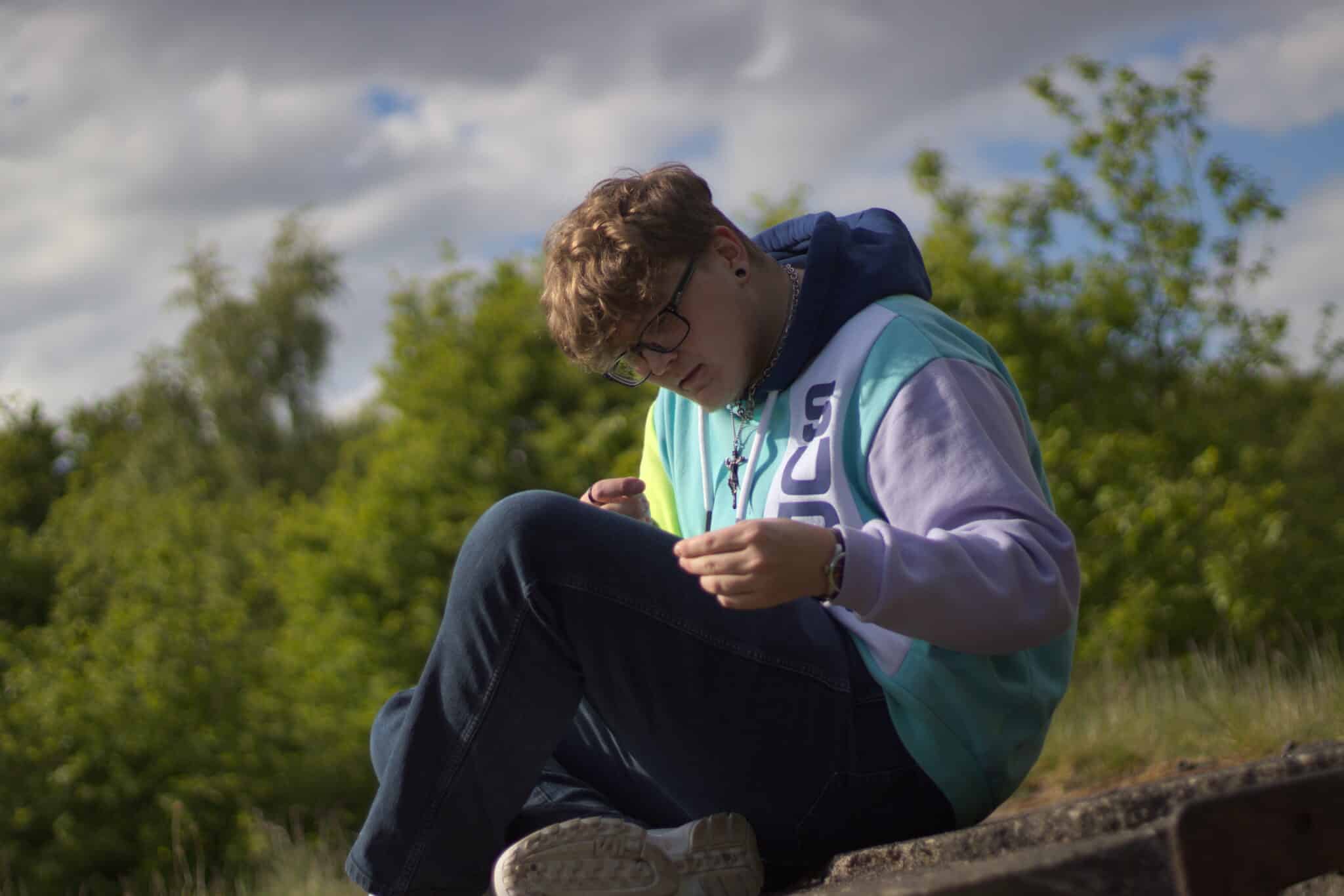student sitting looking at knee