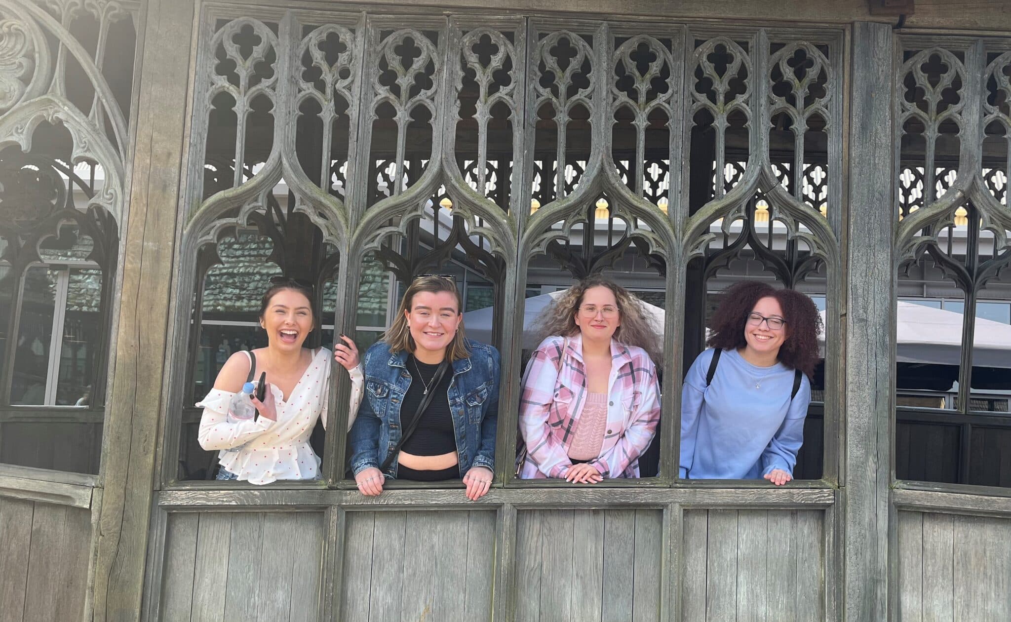 Four students smiling at camera