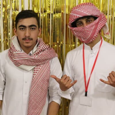 Students headshots in front of gold background