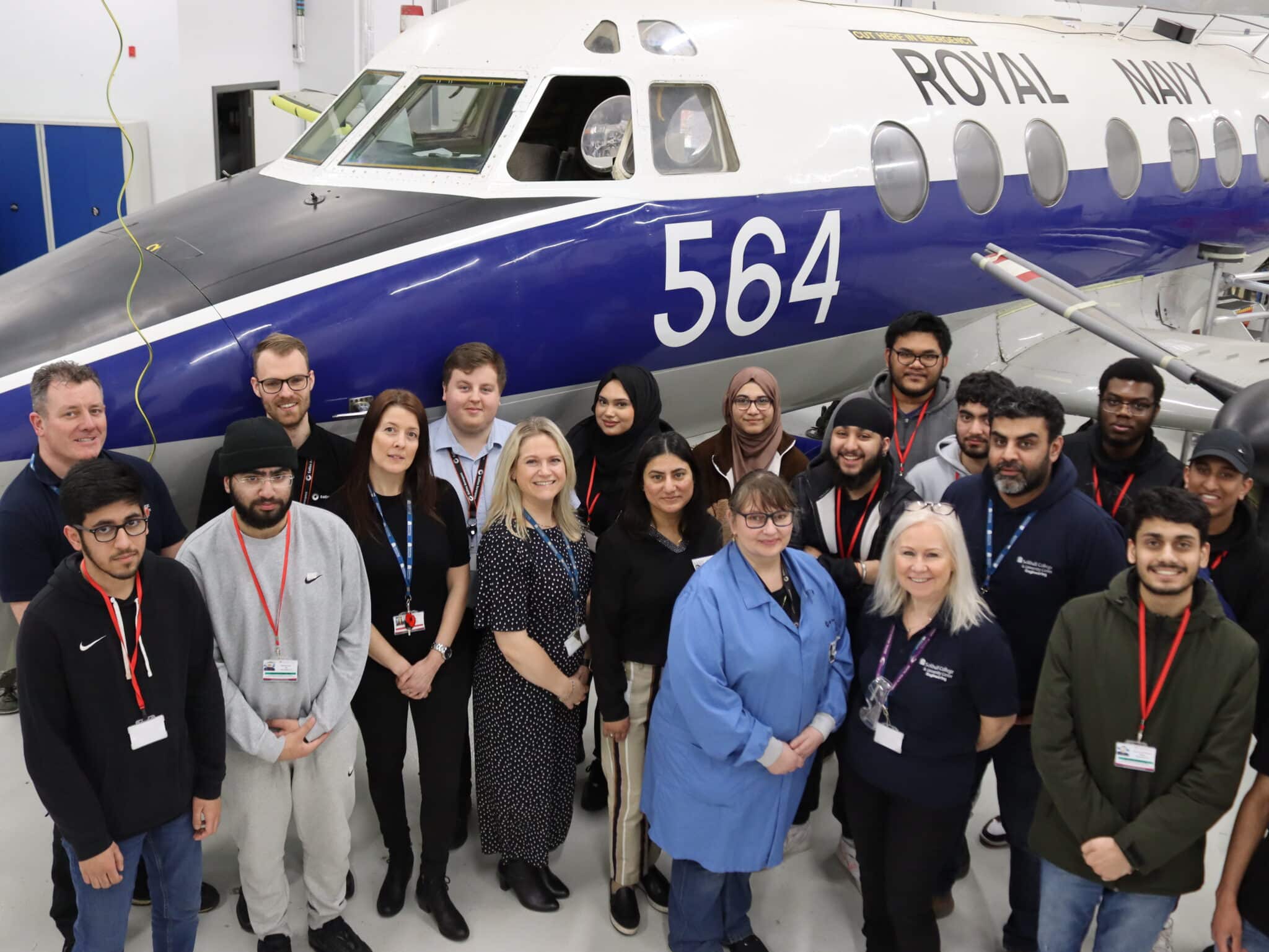 people standing in front of aircraft looking up