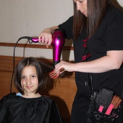woman blowdrying girl's hair