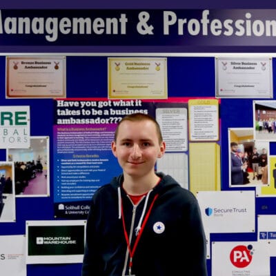 student standing in front of notice board that says 'Management & Professional' at the top