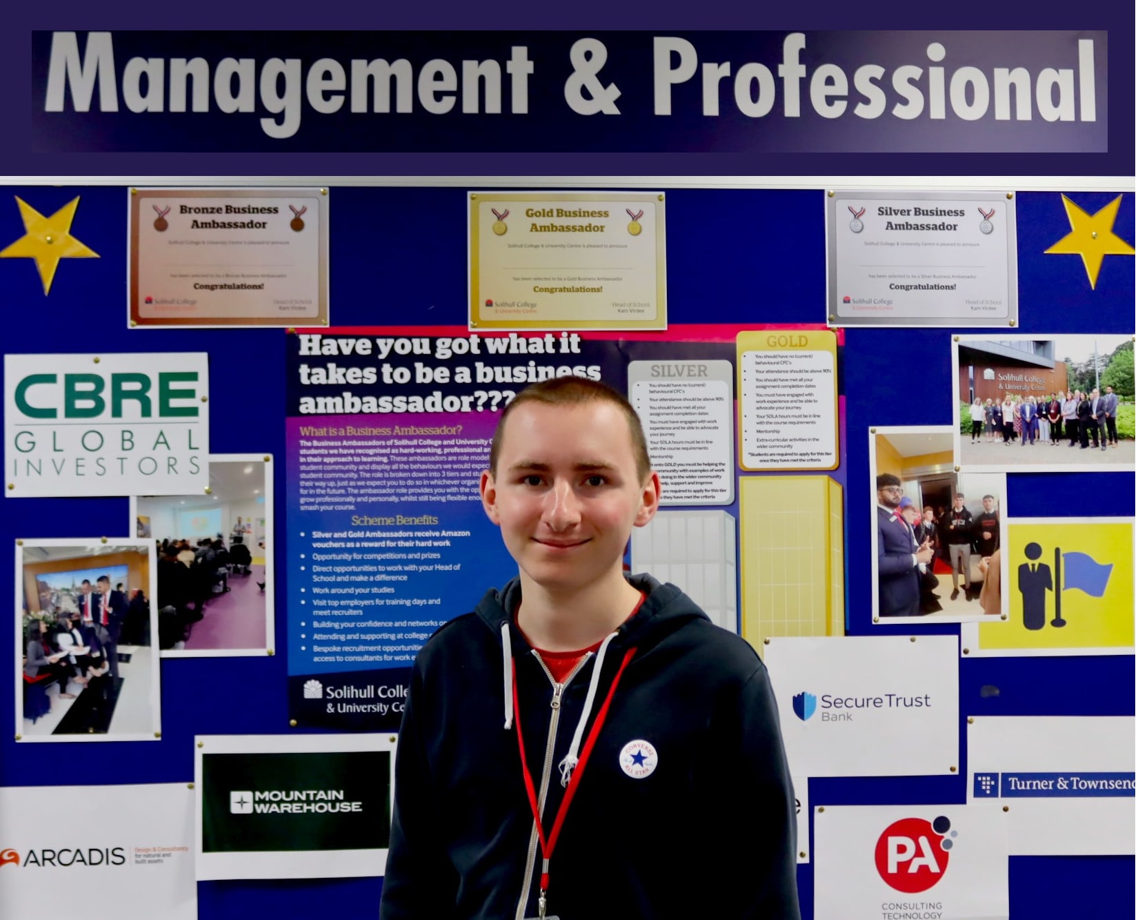 student standing in front of notice board that says 'Management & Professional' at the top