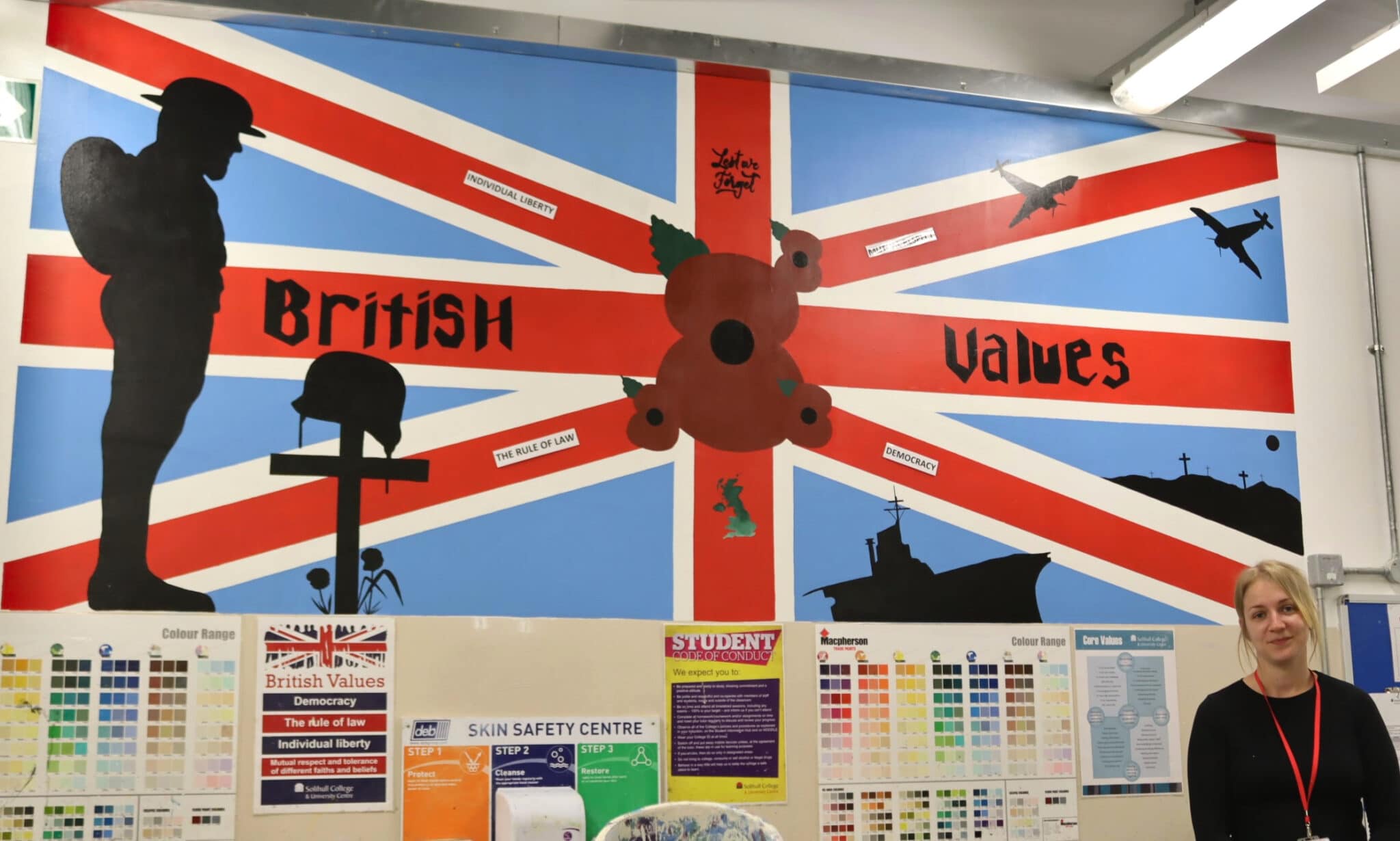 Union Flag Mural on wall with student standing in front