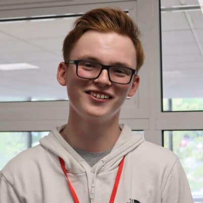 student wearing glasses smiling