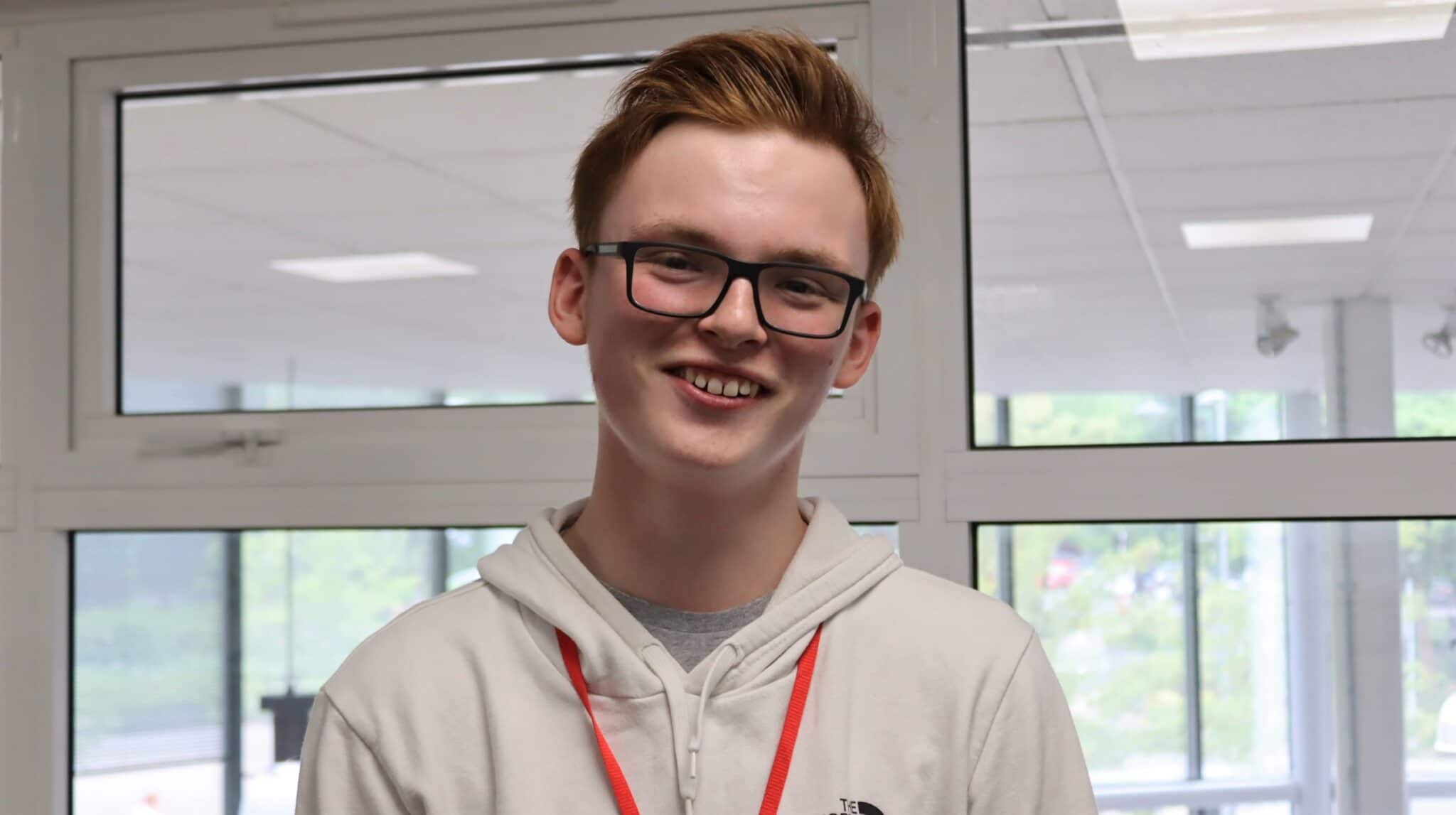 student wearing glasses smiling
