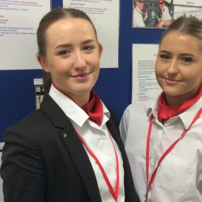 Two female cabin crew students wearing their uniform
