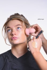 woman applying foundation