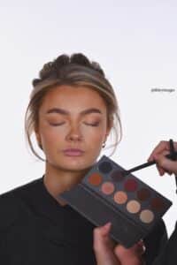 showing brides face next to eyeshadow pallette